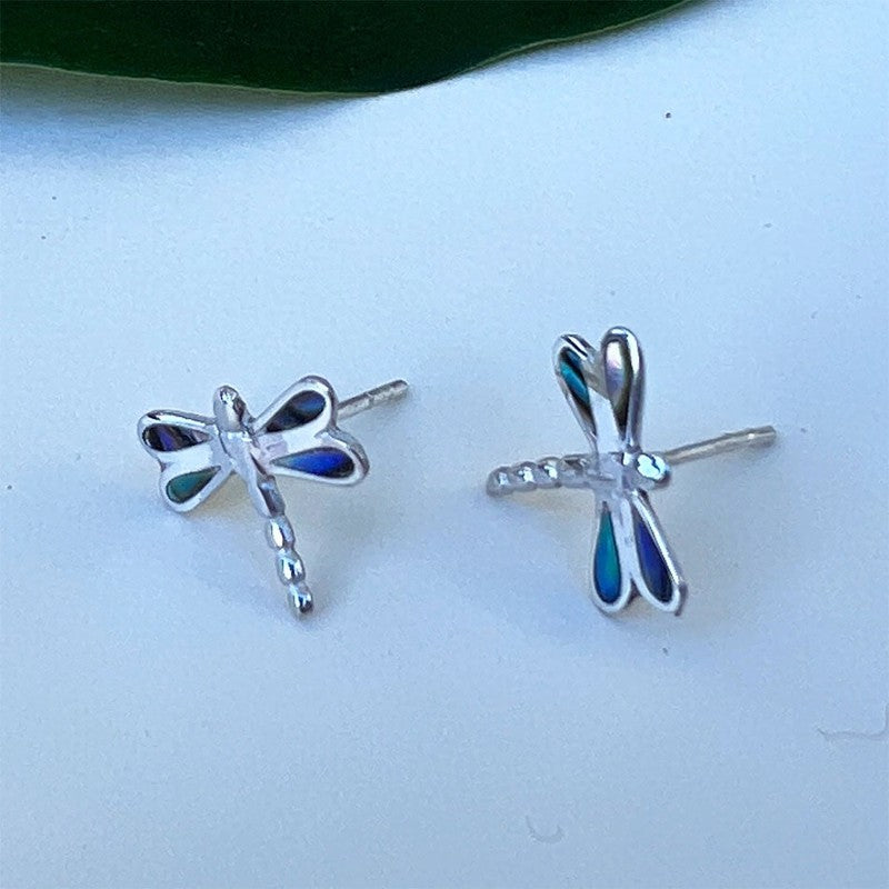 Silver abalone dragonfly stud earrings from Women's Peace Collection featuring detailed, iridescent ocean-inspired jewelry.