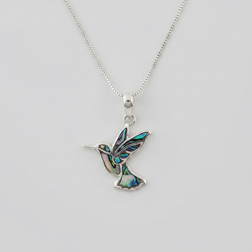 Colorful abalone hummingbird pendant necklace from Women's Peace Collection, featuring vibrant iridescent shell details.