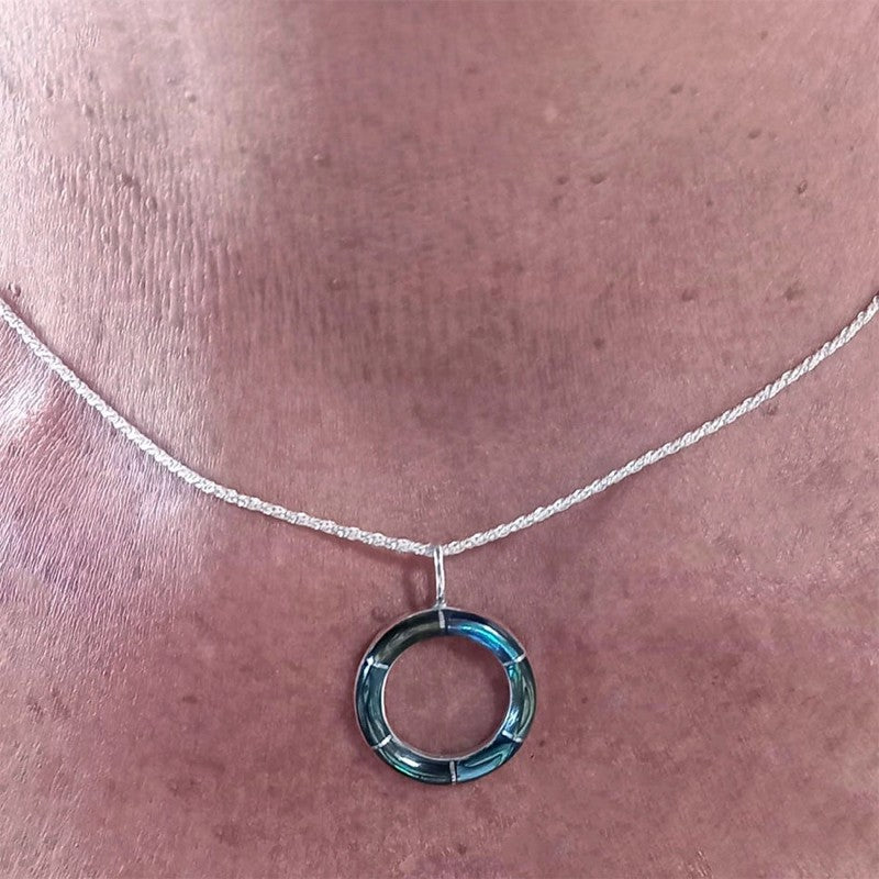 Women's Peace Collection abalone inlay circle necklace featuring a polished, circular pendant with colorful shell inlay.