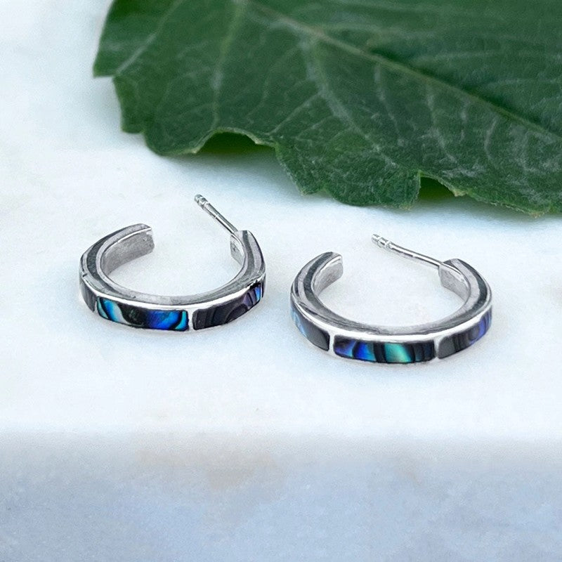 Women's Peace Collection abalone inlay huggie earrings with silver-tone hoops and iridescent shell detailing.