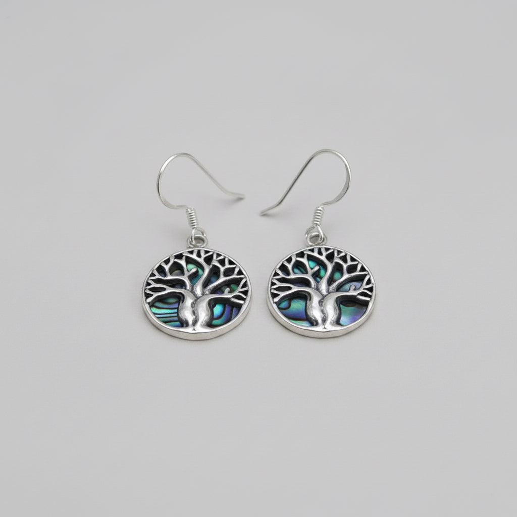 Women's Peace Collection abalone earrings featuring a detailed tree of life design, showcasing iridescent shell accents.