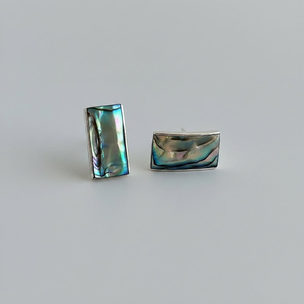 Women's Peace Collection abalone wave earrings featuring shimmering, ocean-inspired design with polished shell accents.