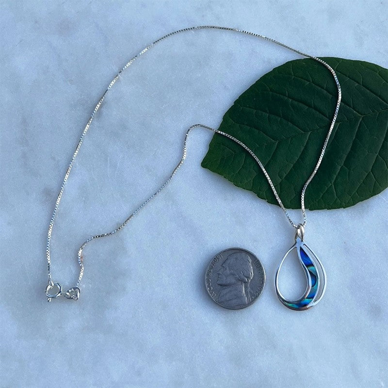 Abalone Waves Necklace from Women's Peace Collection featuring iridescent abalone shell pendants on a delicate chain.
