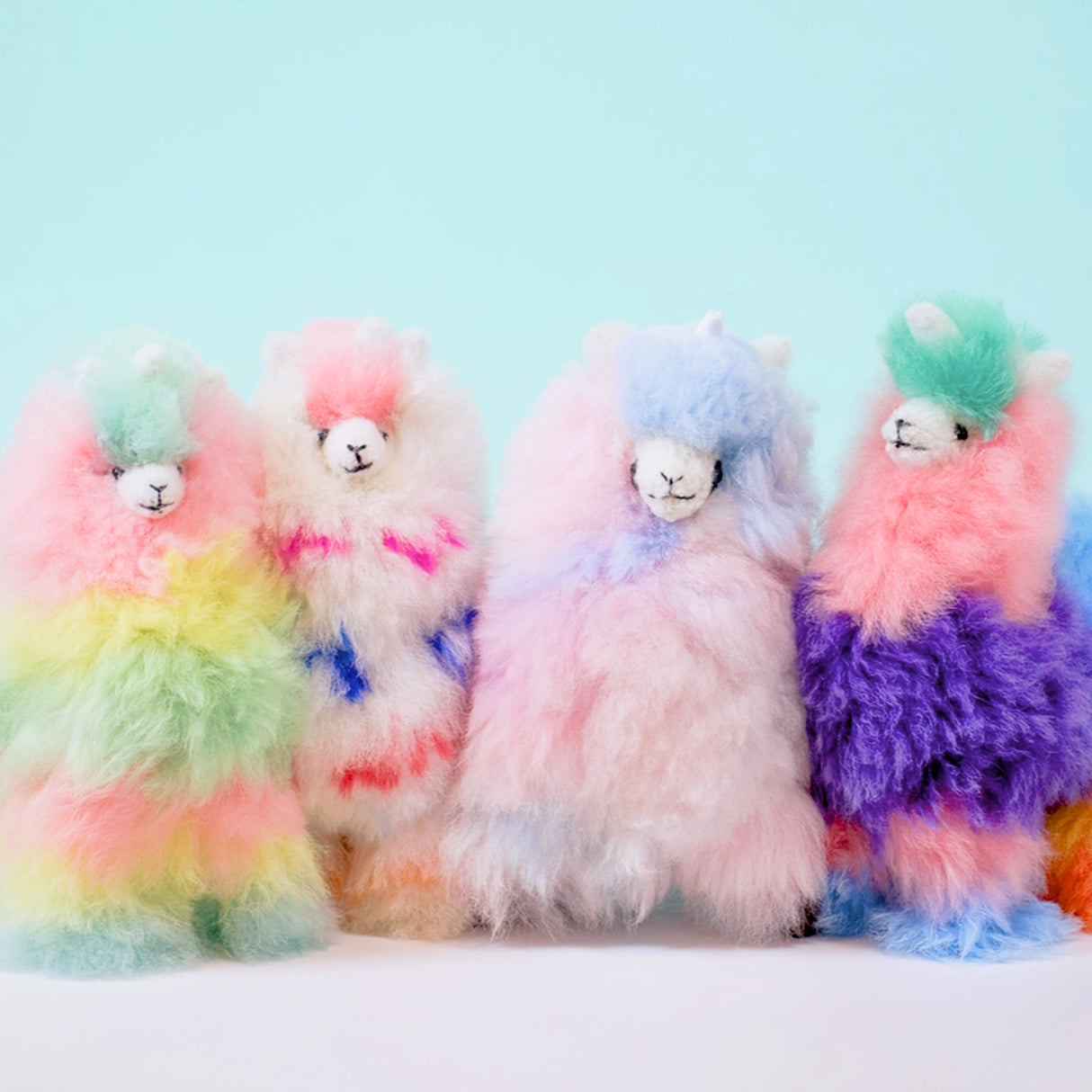 Soft alpaca fur Llamacorn Zesty Twist plush toy by Blossom Inspirations, featuring colorful yarn and whimsical llama unicorn design.