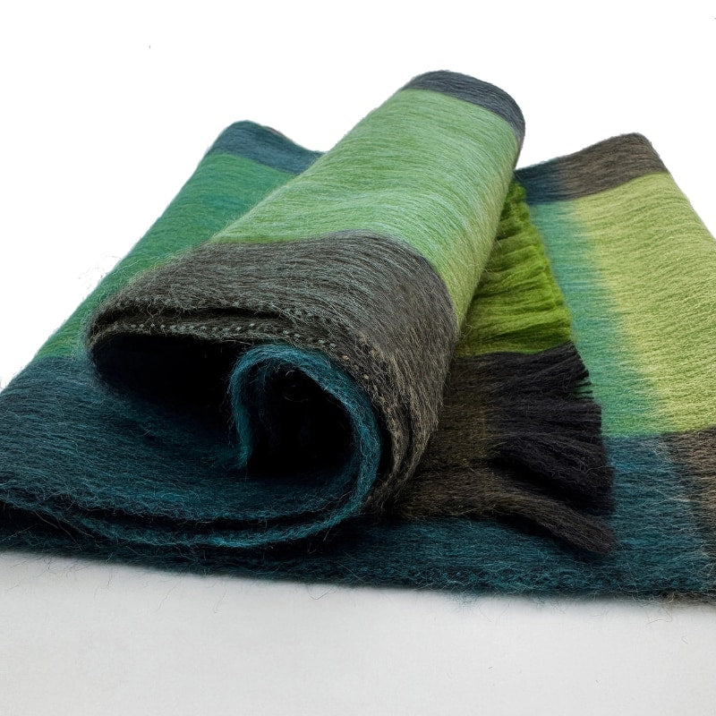 Shupaca Tidepool alpaca plaid scarf featuring soft, warm fabric with a multicolored checkered pattern for stylish comfort.