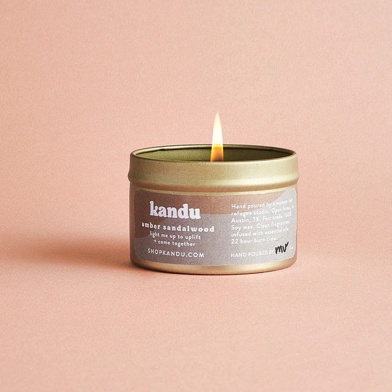 amber sandalwood candle on plain background