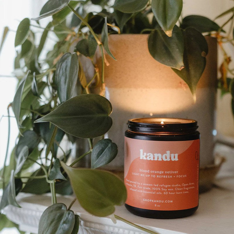 Kandu candle with a plant in the background