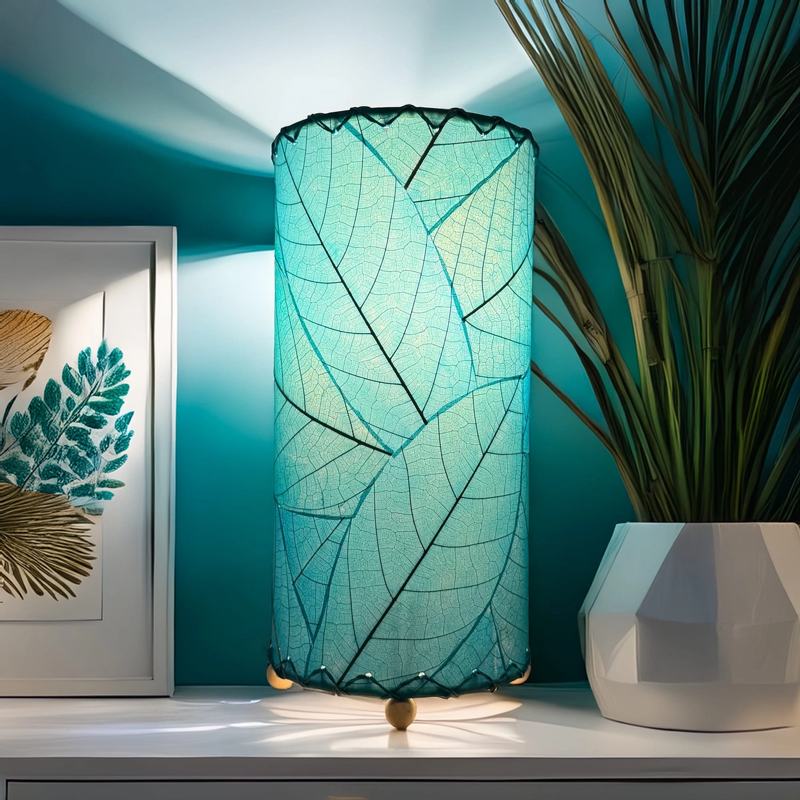 Sea blue Cocoa Leaf Cylinder Table Lamp by Eangee, 12-inch decorative lamp with leaf pattern and vibrant blue finish.