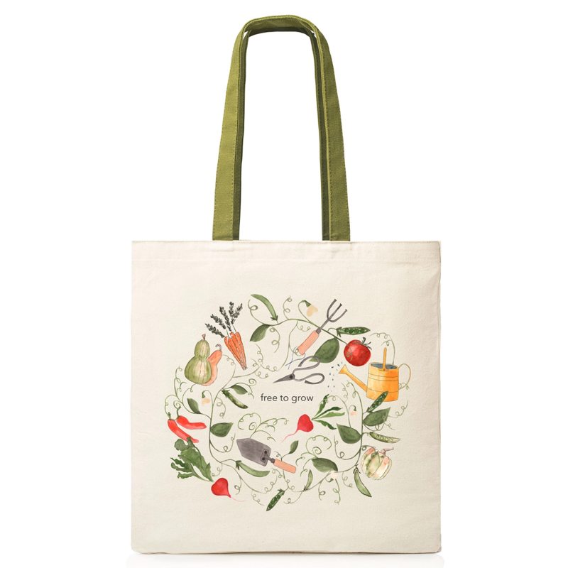Tote bag with gardening-themed design and 'free to grow' text on a white background