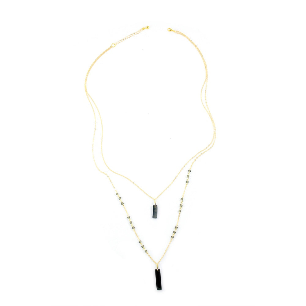 Faire Collection Allie Necklace with a smooth, cool gray pendant on a delicate chain, modern jewelry accessory for stylish looks.