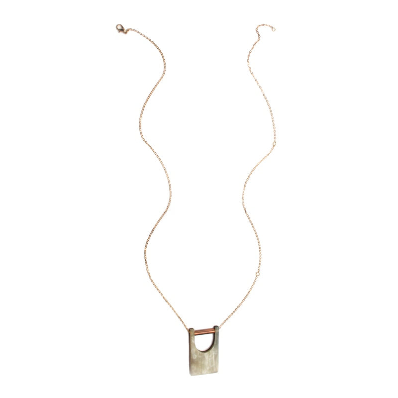 Elegant bridge pendant from Faire Collection, featuring a sleek design with a delicate chain and intricate detailing.