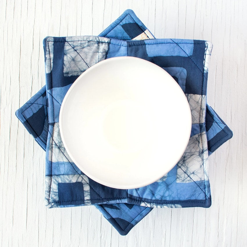 Navy fabric bowl cozy, designed to protect hands from hot bowls with a soft, insulated cloth cover.