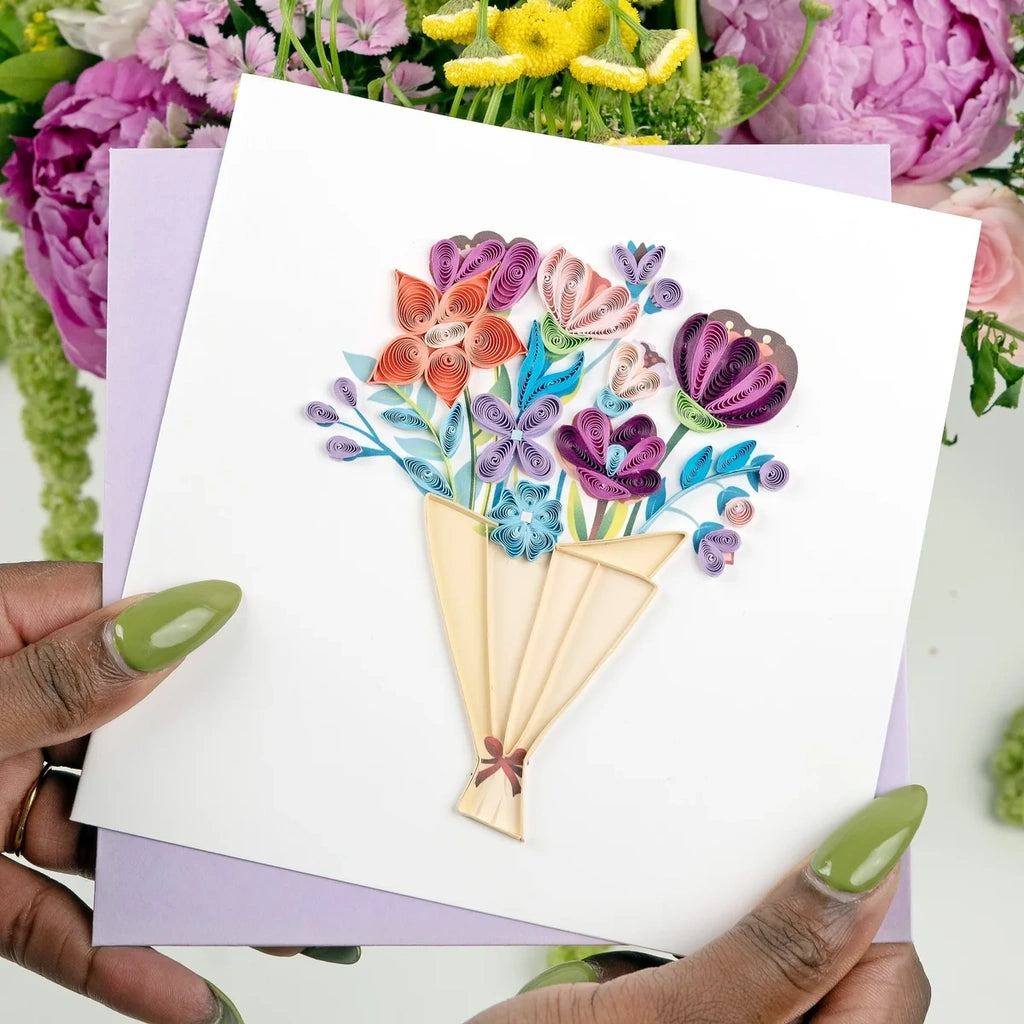 Hands holding a playful flower bouquet quilling card featuring colorful, handcrafted paper flowers and intricate quilling details.