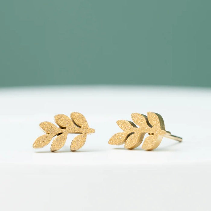 rowen leaf studs frosted gold close