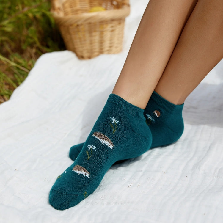 Teal ankle socks by Conscious Step featuring playful hedgehog designs that support pollinator protection.