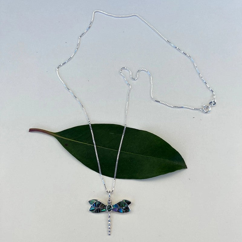 Abalone dragonfly pendant necklace from Women's Peace Collection featuring a colorful, detailed dragonfly design on a silver chain.