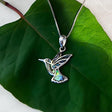 Colorful abalone hummingbird pendant necklace from Women's Peace Collection, featuring vibrant iridescent shell details.