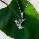 Colorful abalone hummingbird pendant necklace from Women's Peace Collection, featuring vibrant iridescent shell details.