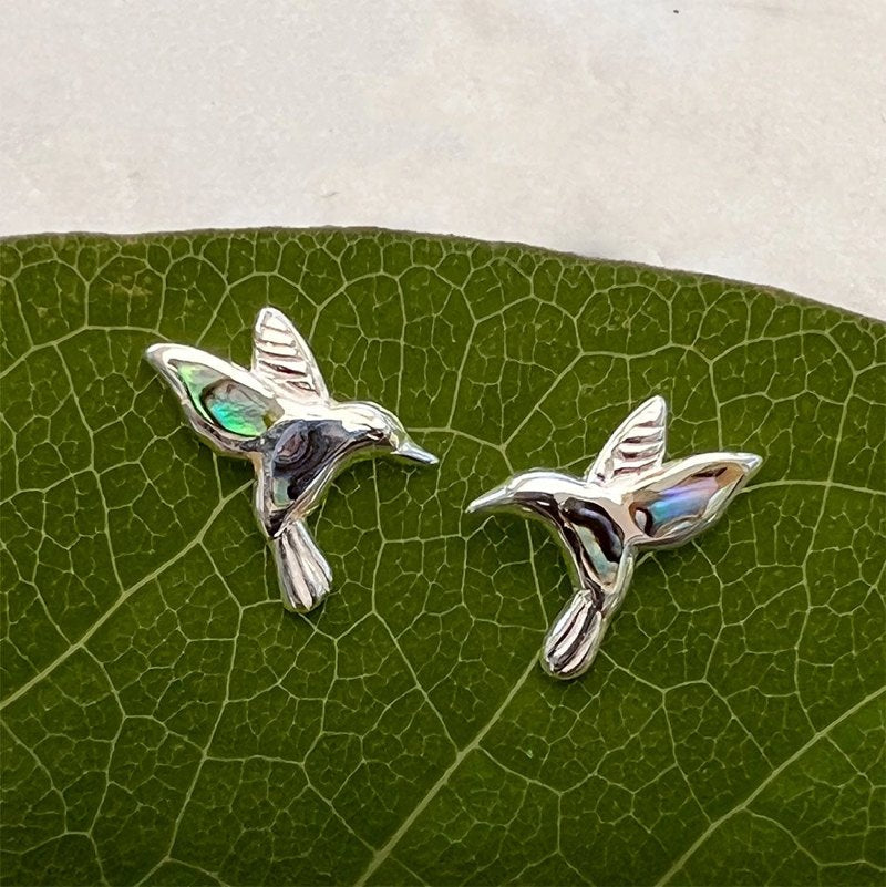Women's Peace Collection abalone hummingbird stud earrings featuring colorful, detailed bird designs on shiny metal posts.
