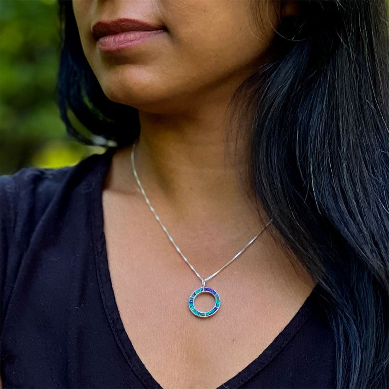Women's Peace Collection abalone inlay circle necklace featuring a polished metal chain and colorful iridescent inlay design.