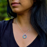 Women's Peace Collection abalone inlay circle necklace featuring a polished metal chain and colorful iridescent inlay design.