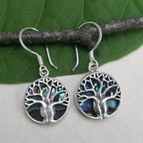 Women's Peace Collection abalone earrings featuring a detailed tree of life design, showcasing iridescent shell accents.