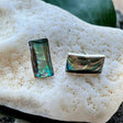 Women's Peace Collection abalone wave earrings featuring shimmering, ocean-inspired design with polished shell accents.