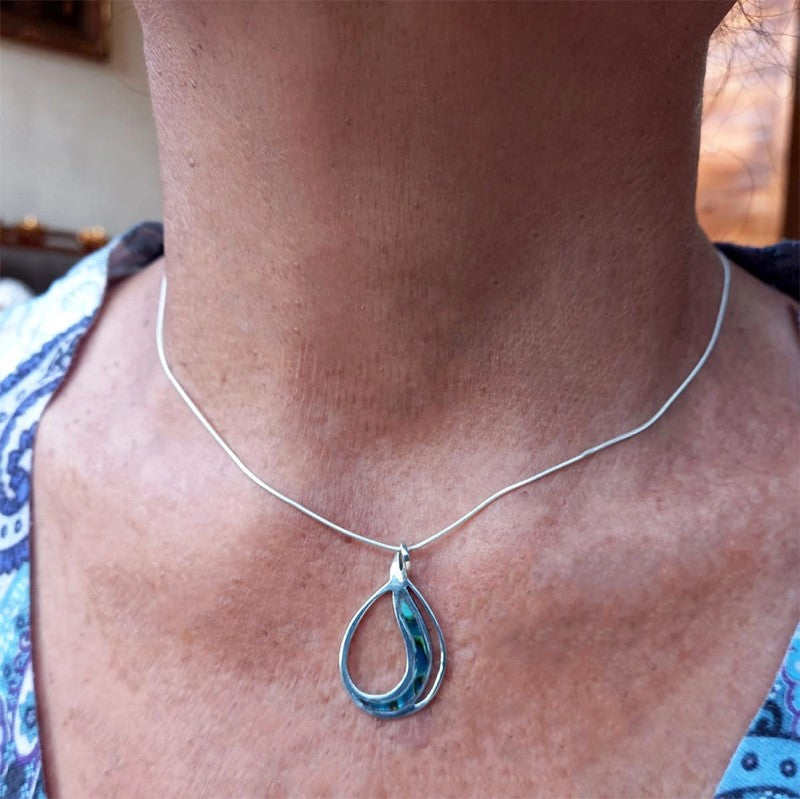 Abalone Waves Necklace from Women's Peace Collection featuring iridescent shell pendant on a delicate chain.