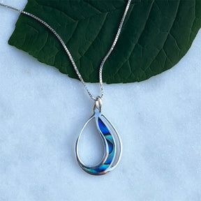Women's Peace Collection abalone waves necklace featuring iridescent shell pendant on a delicate chain, showcasing ocean-inspired design.