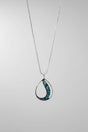 Women's Peace Collection abalone waves necklace featuring iridescent shell pendant on a delicate chain, showcasing ocean-inspired design.