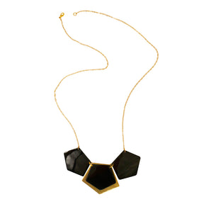 Almeda Necklace by Faire Collection featuring a delicate chain with intricate pendant and elegant design.