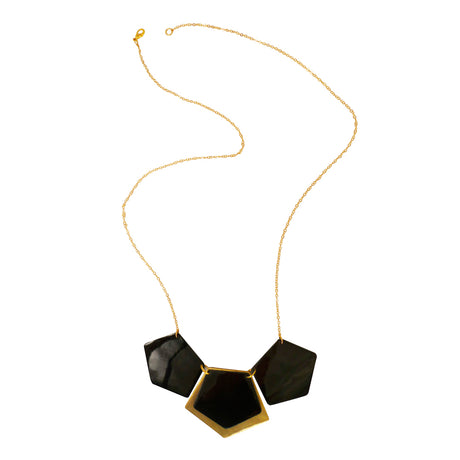 Almeda Necklace by Faire Collection featuring a delicate chain with intricate pendant and elegant design.