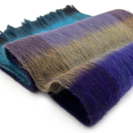 Shupaca alpaca plaid scarf in Nightfall with soft, cozy woven fabric and classic checkered pattern, close-up view.