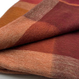 Soft amber alpaca throw blanket from Shupaca, showcasing its cozy, textured fabric and elegant drape.