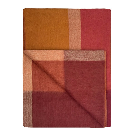 Shupaca alpaca throw blanket in warm amber color, soft and cozy for added comfort and style.