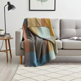 Soft alpaca throw blanket from Shupaca with a colorful prism pattern, perfect for cozying up on the sofa or bed.