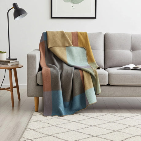 Soft alpaca throw blanket from Shupaca with a colorful prism pattern, perfect for cozying up on the sofa or bed.