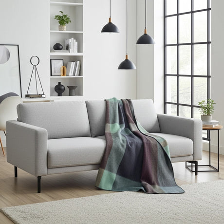 Soft alpaca throw blanket in twilight color from Shupaca, showcasing its cozy, textured fabric draped on a couch.