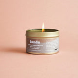 amber sandalwood candle on plain background