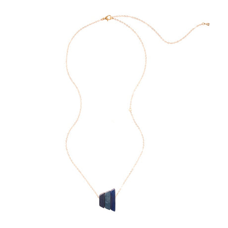 Andes Pendant from Faire Collection featuring denim blue beads and silver accents, hanging from a delicate chain.