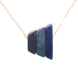 Andes Pendant in denim blues by Faire Collection showcasing a handcrafted silver pendant with blue denim-inspired accents.