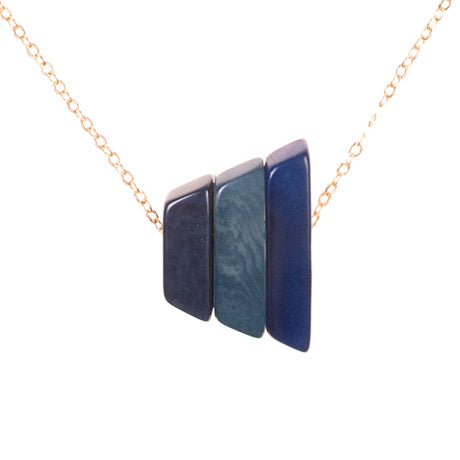 Andes Pendant in denim blues by Faire Collection showcasing a handcrafted silver pendant with blue denim-inspired accents.
