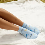 Conscious Step ankle socks featuring playful songbird illustrations, designed to protect and support songbirds.