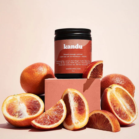 Kandu product jar with blood oranges on a beige background