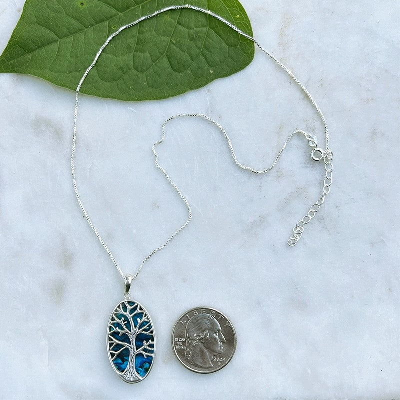 Blue Abalone Tree of Life necklace featuring a detailed pendant on a silver chain, from Women's Peace Collection.