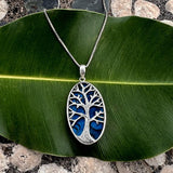 Blue Abalone Tree of Life necklace featuring a vibrant, handcrafted design from Women's Peace Collection.