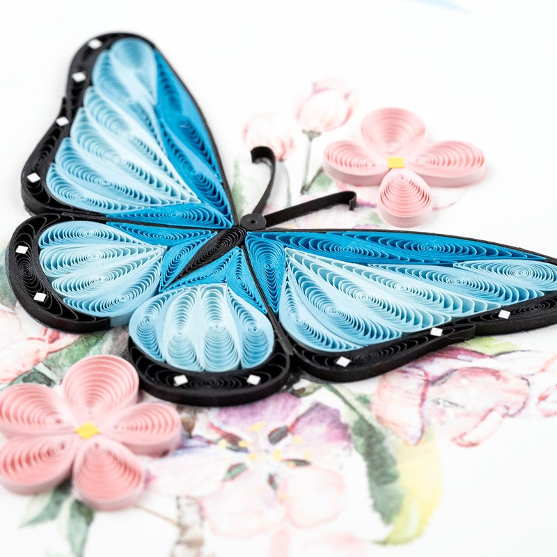 Blue butterfly and pink flower quilling card with intricate paper art, showcasing colorful handmade floral and insect designs.