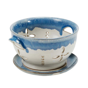 Ceramic colander with blue and white design on a white background