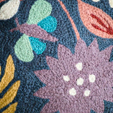 Botanical 18-inch navy chainstitch pillow close up, featuring detailed botanical embroidery on soft fabric.