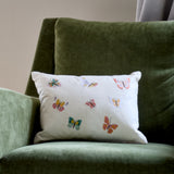 Decorative 12x16-inch embroidered pillow with colorful butterfly design by Natural Habitat, featuring detailed butterfly embroidery on fabric.